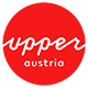 Logo Upper Austria Tourism: red circle with white upperaustria lettering